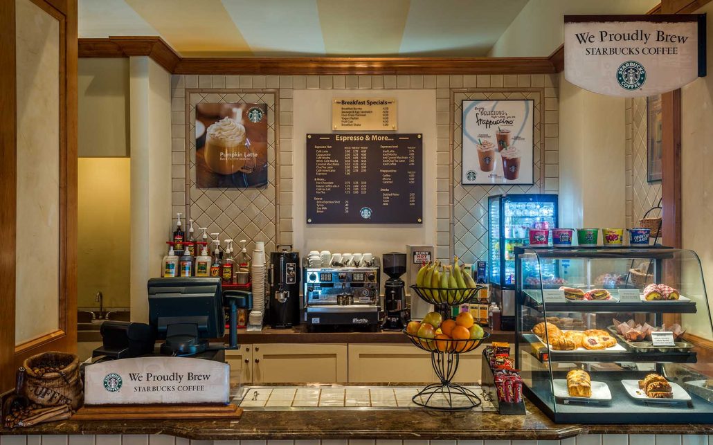 Lobby coffee bar at Hilton Santa Clara featuring Starbucks® drinks, pastries, and grab-and-go breakfast options.