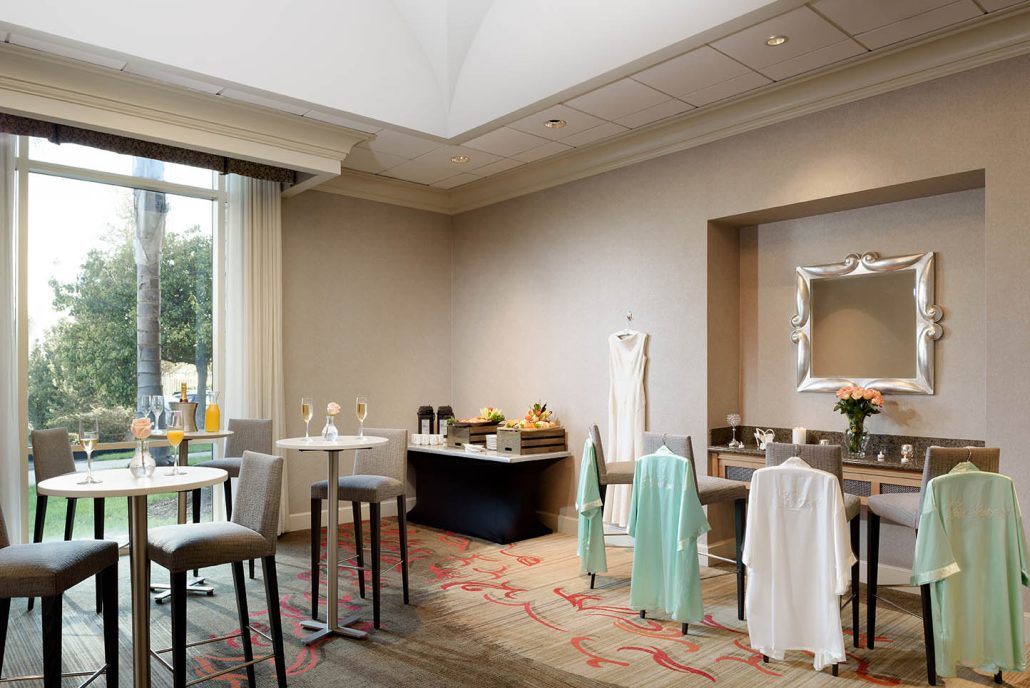 Sunlit event space set for a wedding at Hilton Santa Clara, showcasing Santa Clara catering for events with elegant table settings.