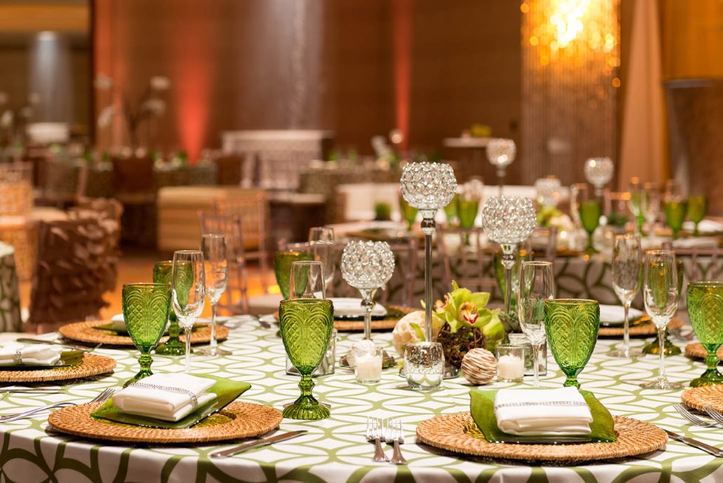 Culturally inspired wedding table setting with green glassware at Hilton Santa Clara, a flexible Santa Clara wedding venue.